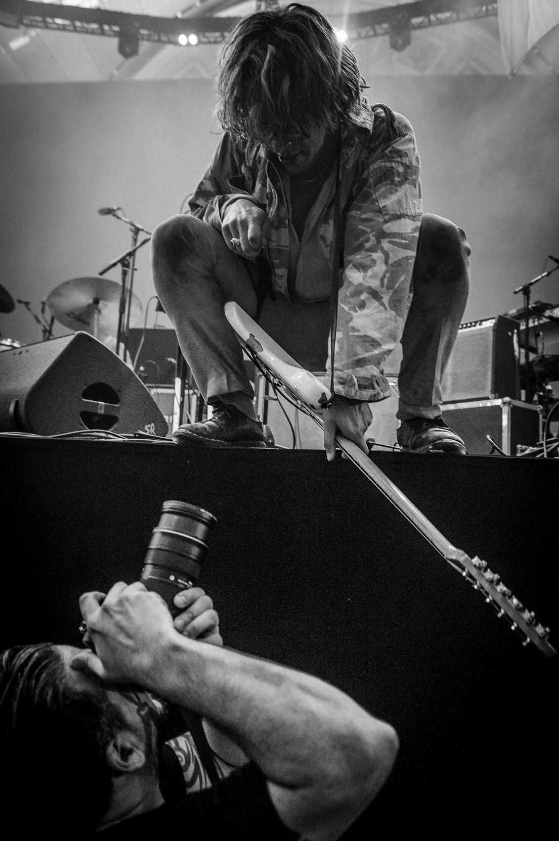Guitarist leaning over the photo pit, shot by Jason Miller